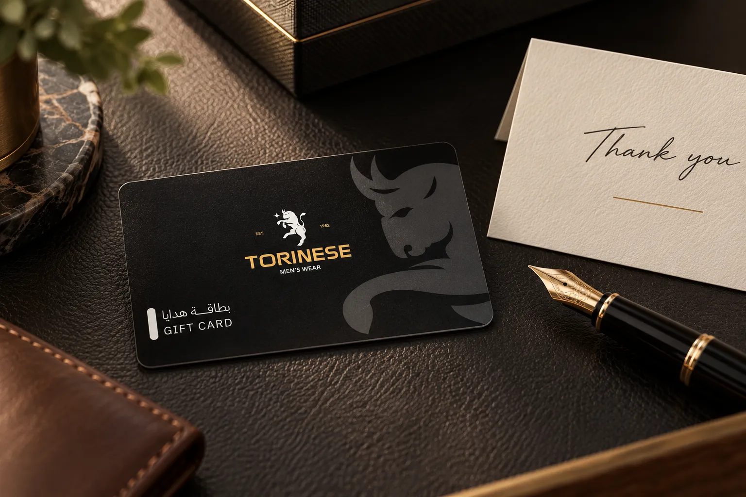 A printed corporate gift card next to a thank-you note